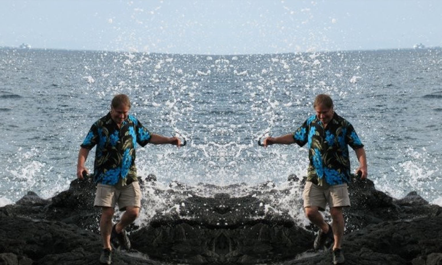 A photo of Fred Wilkins on a jetty at the beach. It is mirrored in the middle.
